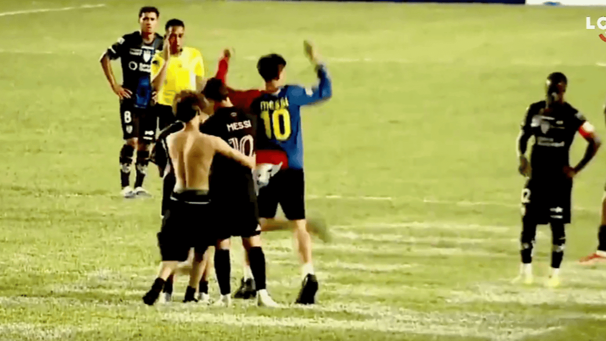 Lionel Messi taken down by pitch invader as opposing player forced to protect him