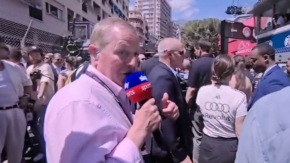 Martin Brundle walks past Premier League footballer during Monaco GP gridwalk