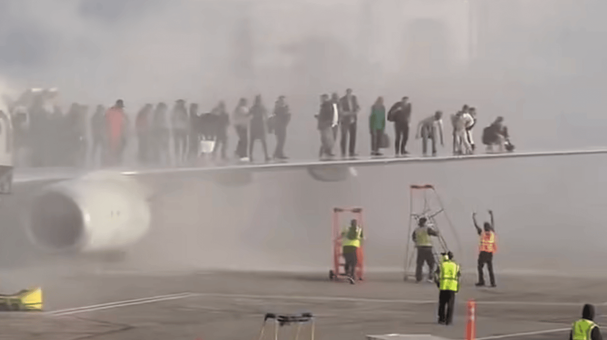 Passengers forced to escape onto wings as plane bursts into flames in ...