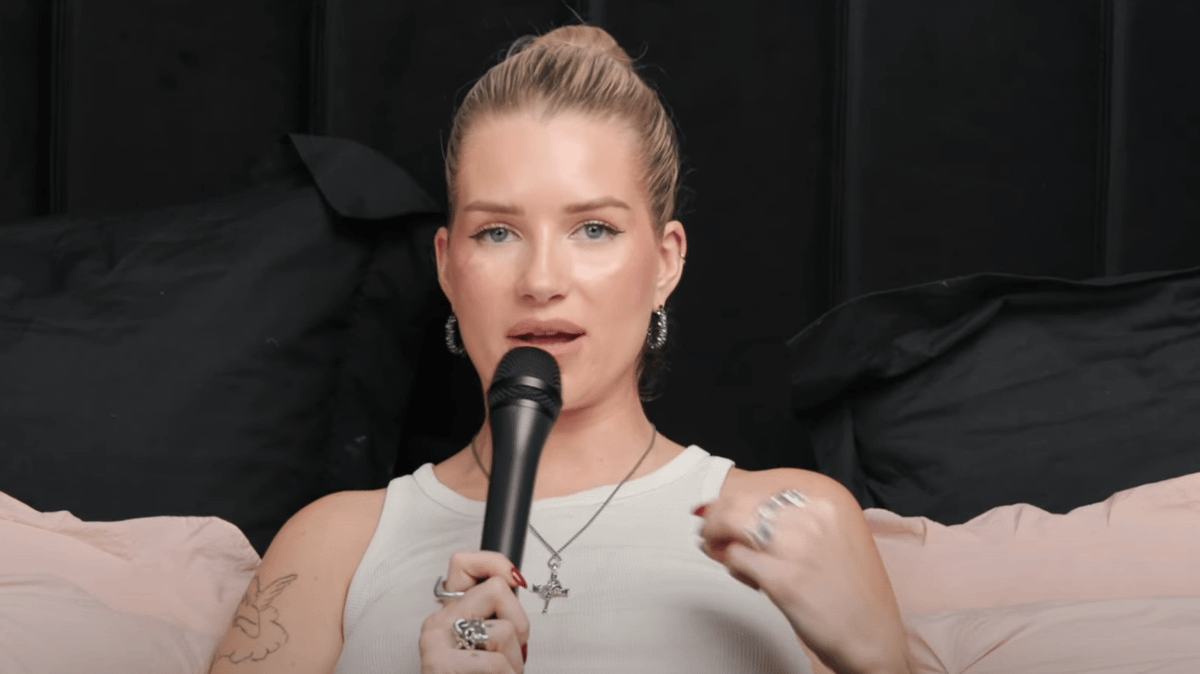 Lottie Moss speaking into a microphone during an interview