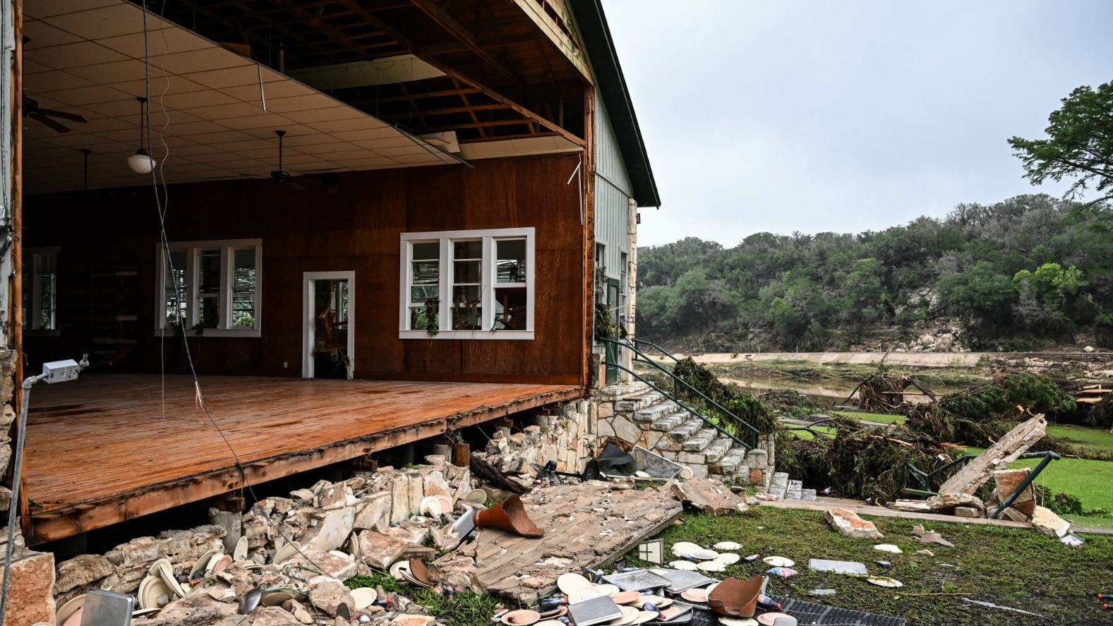 Camp director killed during devastating floods whilst trying to save girls as at least 26 others dead