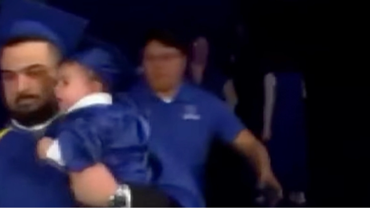 Graduate chased on stage during ceremony by police after making promise to his son