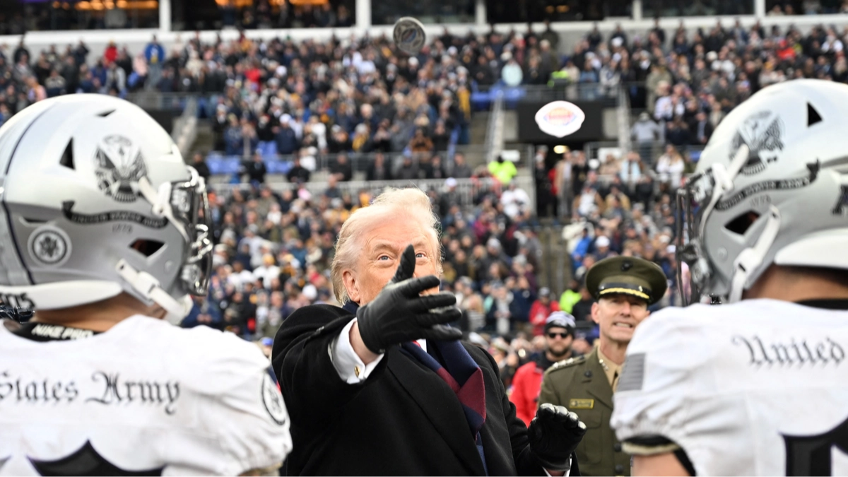 Fans are saying the same thing after Trump 'fumbles' coin toss at football game