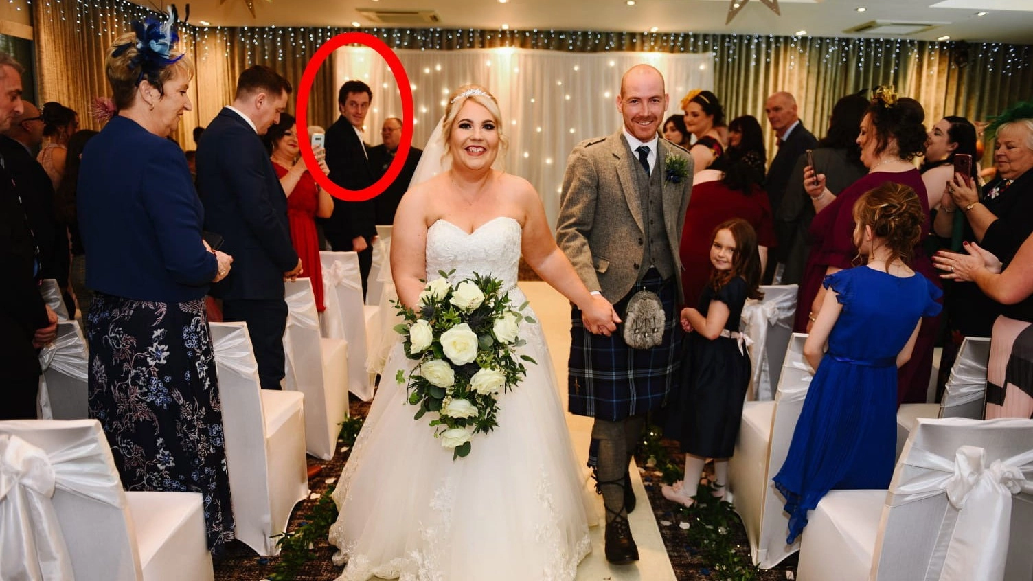 Couple finally discover wild truth behind mysterious stranger in their wedding picture four years later