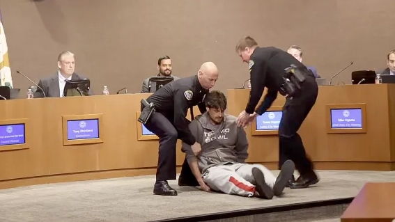 Ex-NFL player arrested after calling MAGA 'a Nazi movement' in heated protest at library