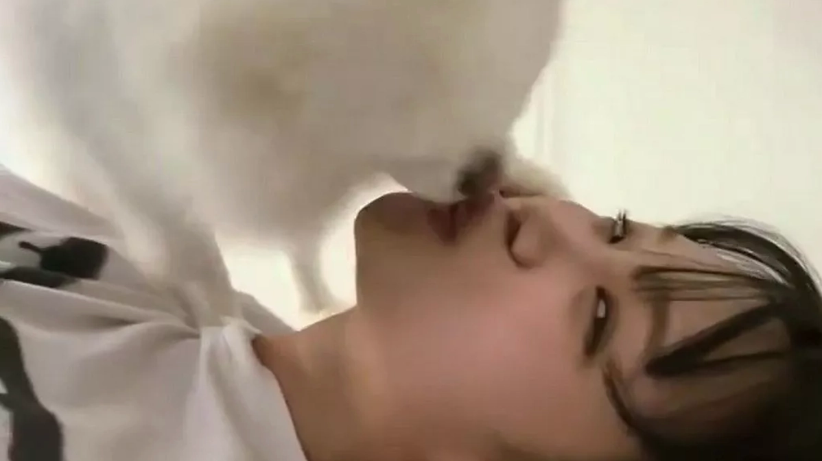Pop star berated after performing dodgy act on dog that she 'loves a little too much'