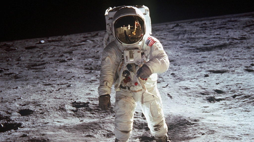 Artist enhanced reflection of Buzz Aldrin's helmet in famous moon photo and pointed towards one detail
