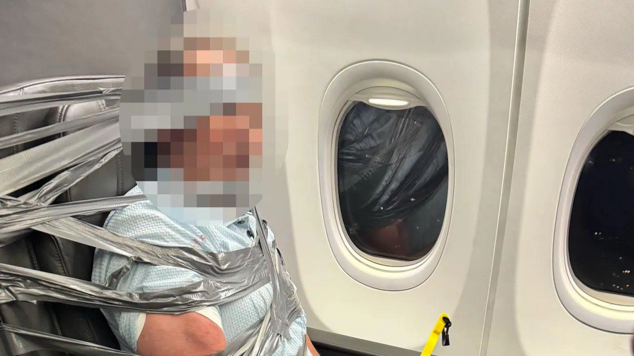 'Violent' passenger duct-taped to seat mid-flight after allegedly shouting racial slur and homophobic comments at air hostess