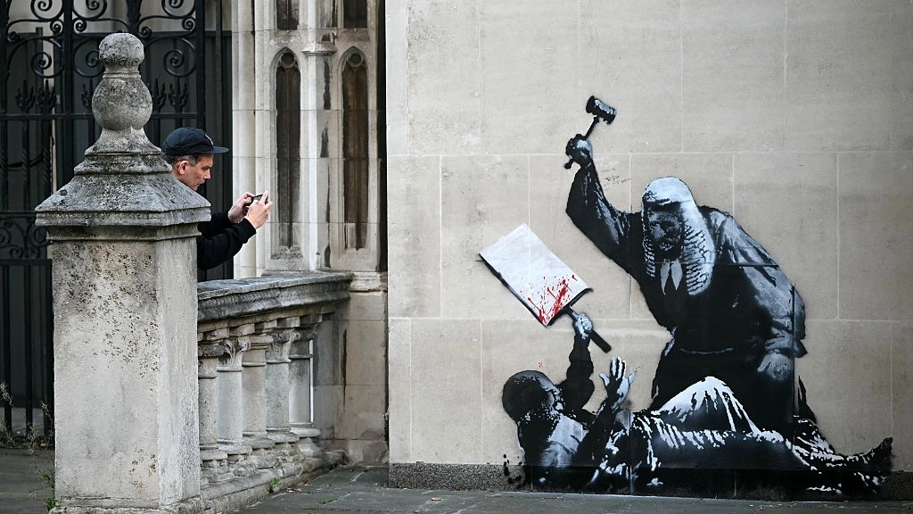 Banksy's identity could be revealed as his new artwork is already scrubbed off walls