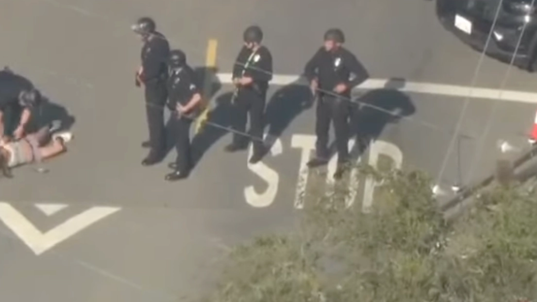 Footage shows police approaching the wife of Weezer's bassist as she was shot after pointing a gun at them