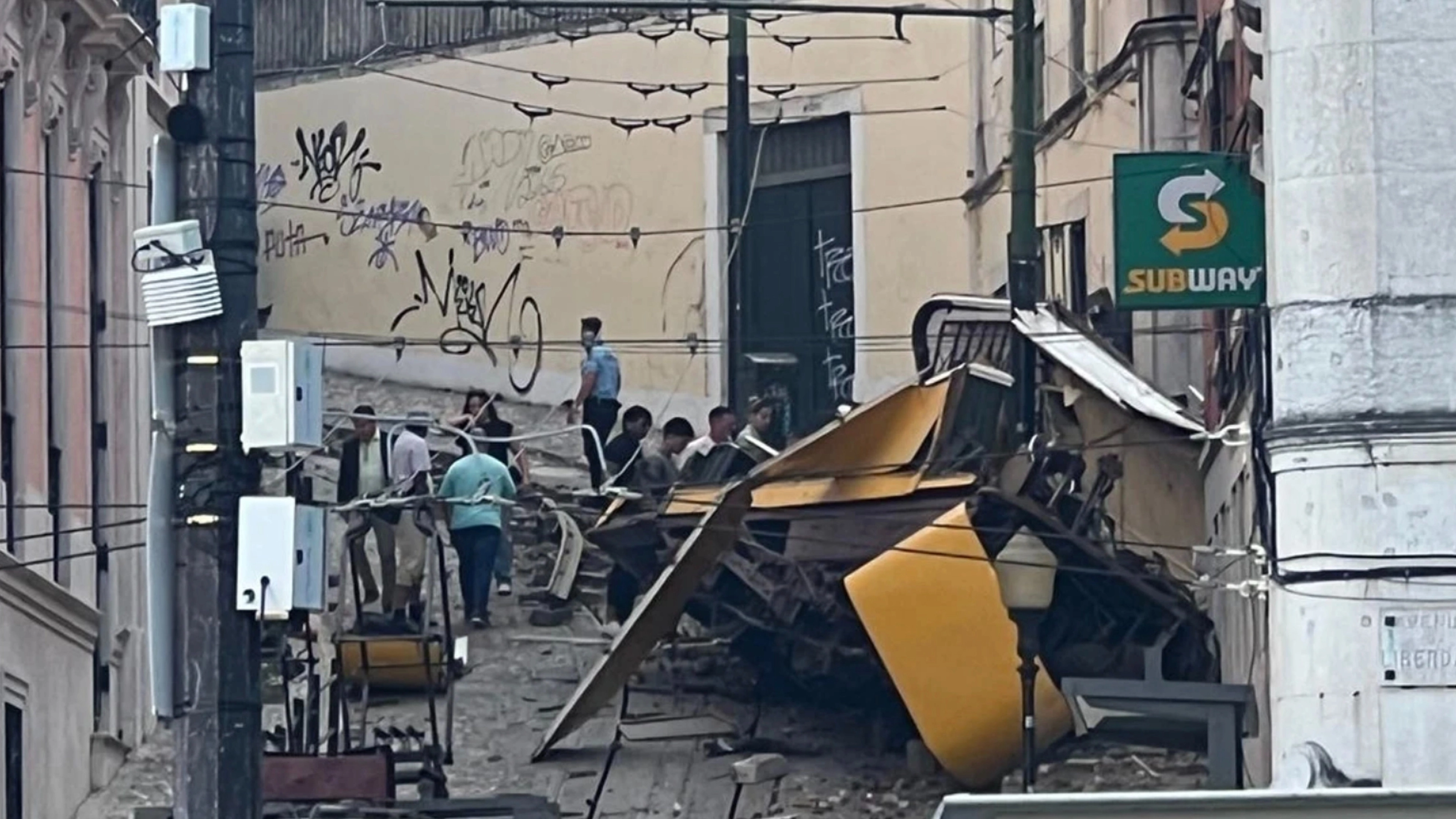 Horror footage of people shouting 'there's kids under there' after Lisbon tram crash kills 15 and injures 23 more