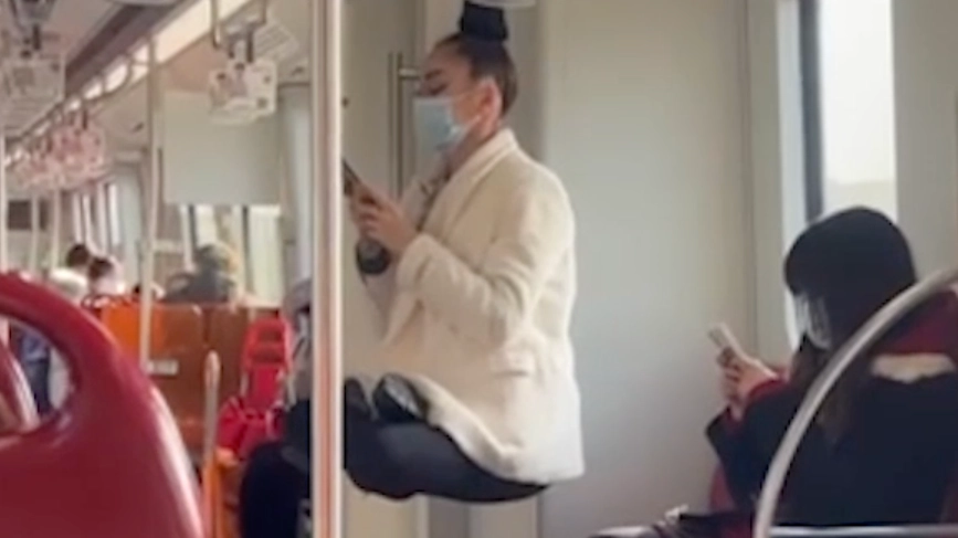 Woman Seems To Levitate As She Hangs By Her Hair On A Train