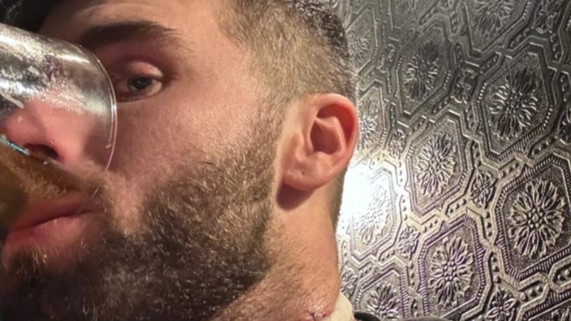 Man who had neck slashed open in random 'knife attack' shares photo in pub hours later downing pint