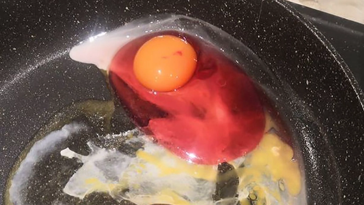 Mum Shocked After Cracking Strange Discoloured Egg Into Her Frying Pan