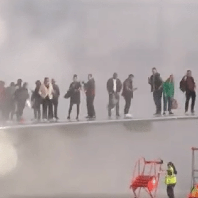 Plane bursts into flames at Denver International forcing passengers to stand on wing as they evacuate