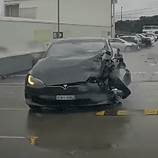 Runaway Tesla crashes into three cars and drives off shopping center car park rooftop