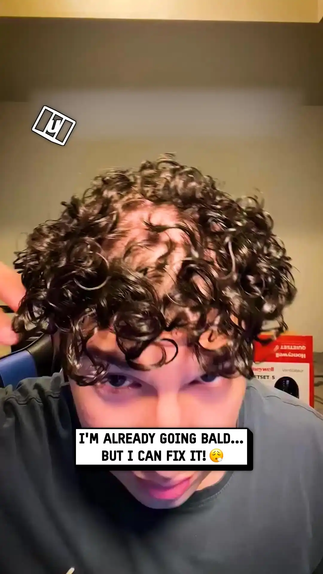 Fixing his curls