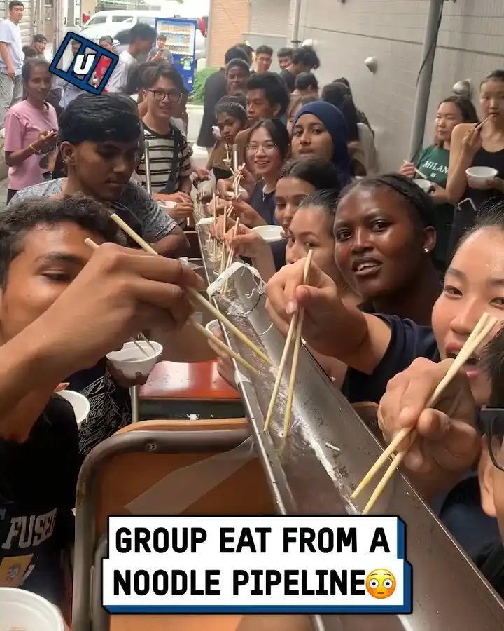 Group eat from a noodle pipeline 🍜 🎋