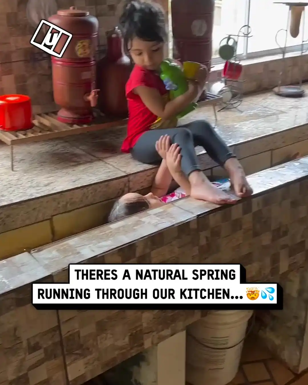 Unique sink goes the whole length of this kitchen