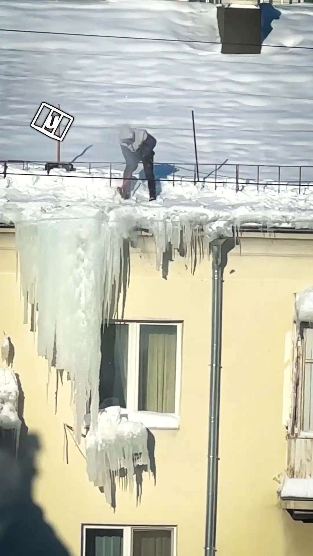 Guy Knocks Down Icicles Along With Air Conditioners