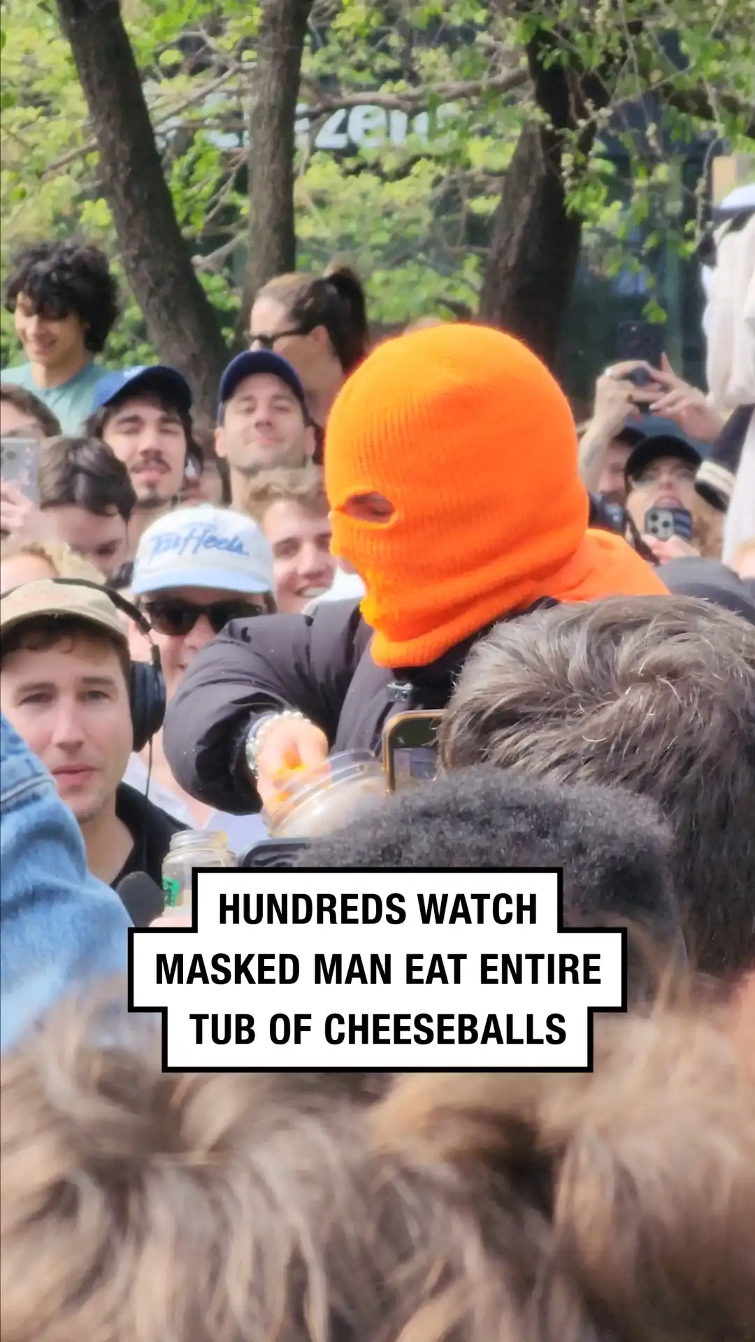 Hundreds watch masked man eat entire tub of cheeseballs