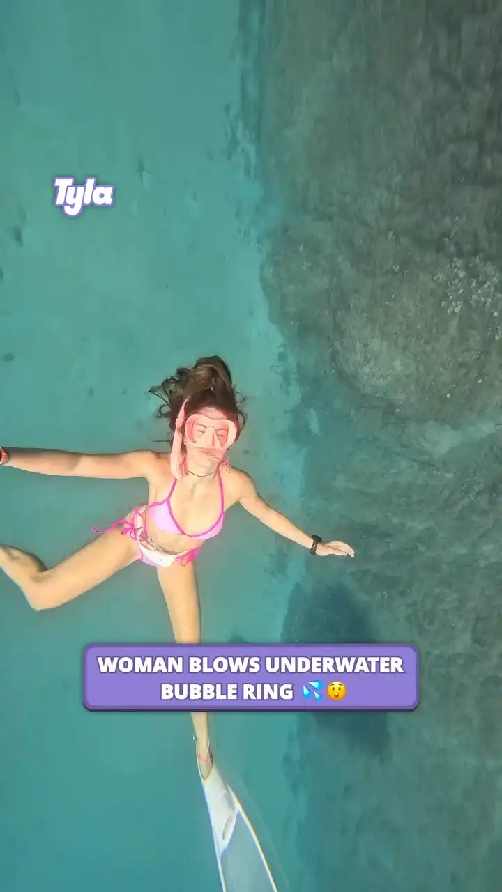 Woman blows underwater bubble ring 🫧
