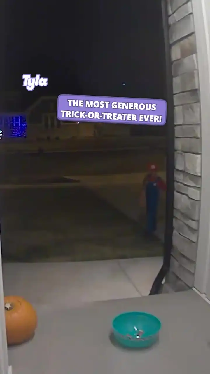 Trick or treating kid fills empty bowl with own sweets