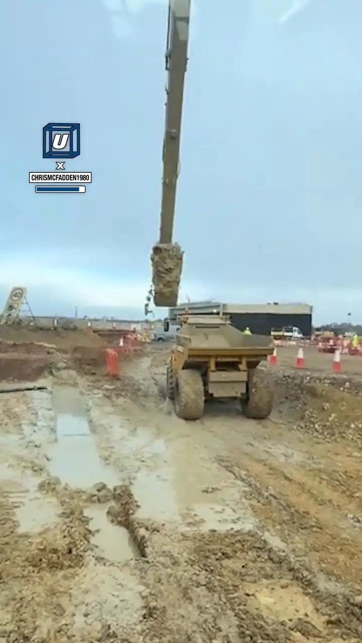 Excavator goes deep into puddle