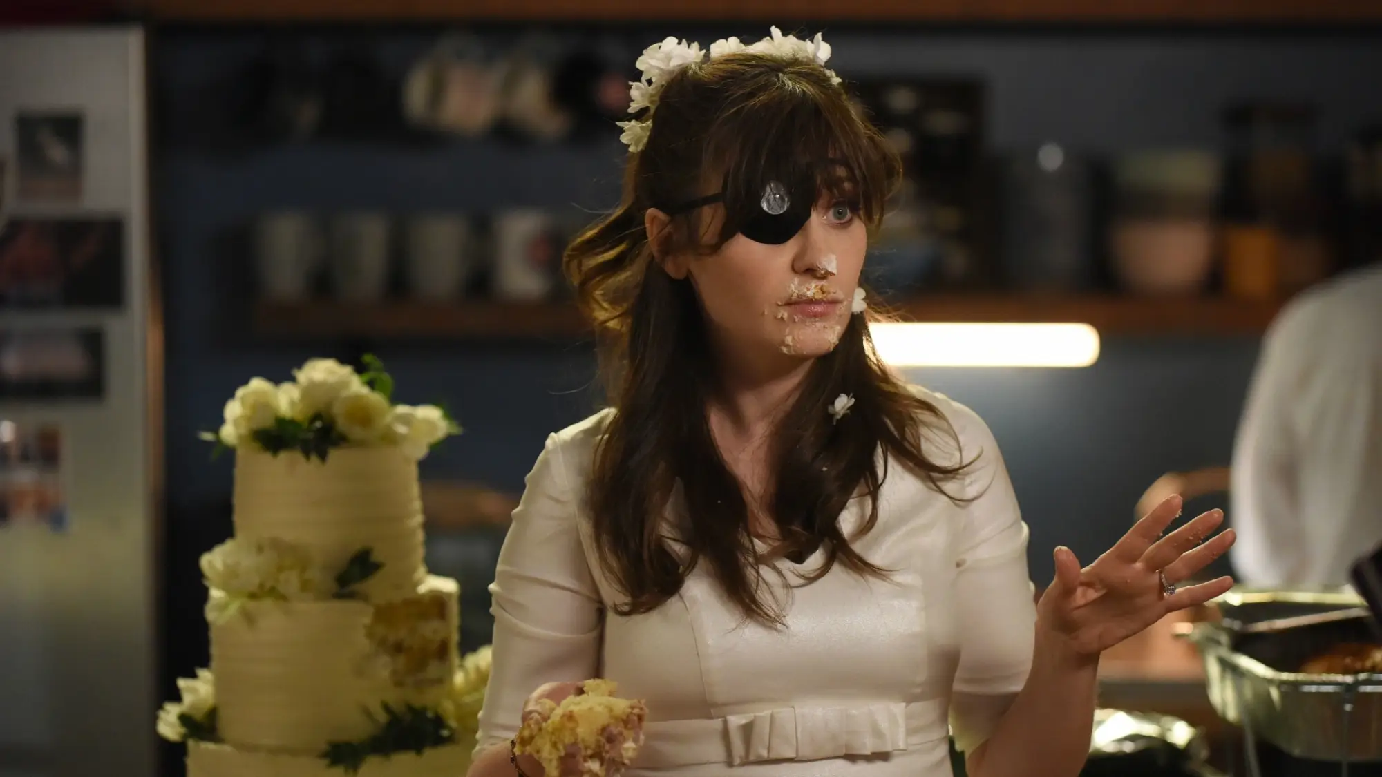 Jess is dressed in her wedding gown and eye patch.