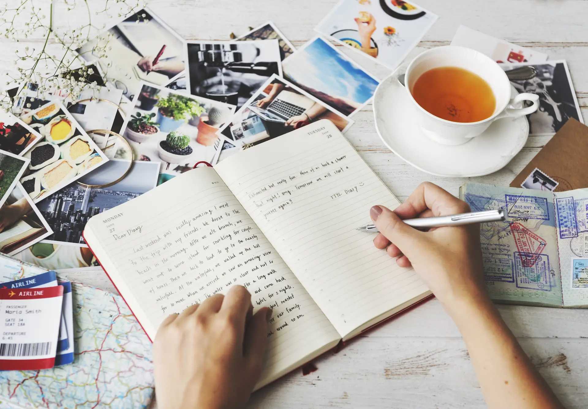 Hands Writing Travel Journal Tea Concept