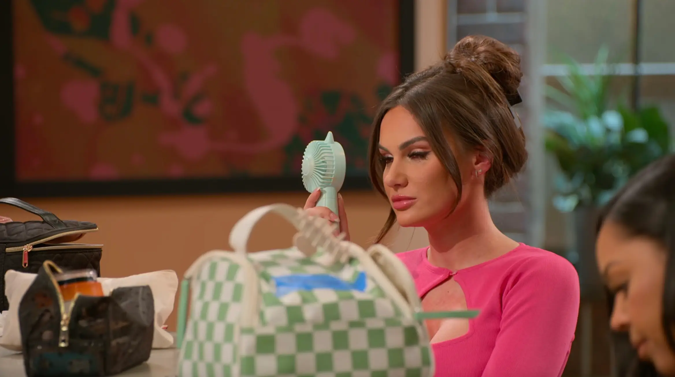 Jessica from 'Love Is Blind' using a personal fan to dry her tears.