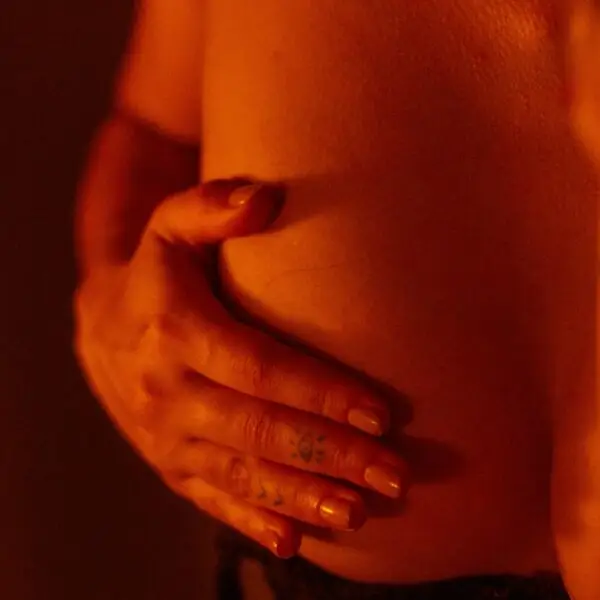 woman with hand on breast