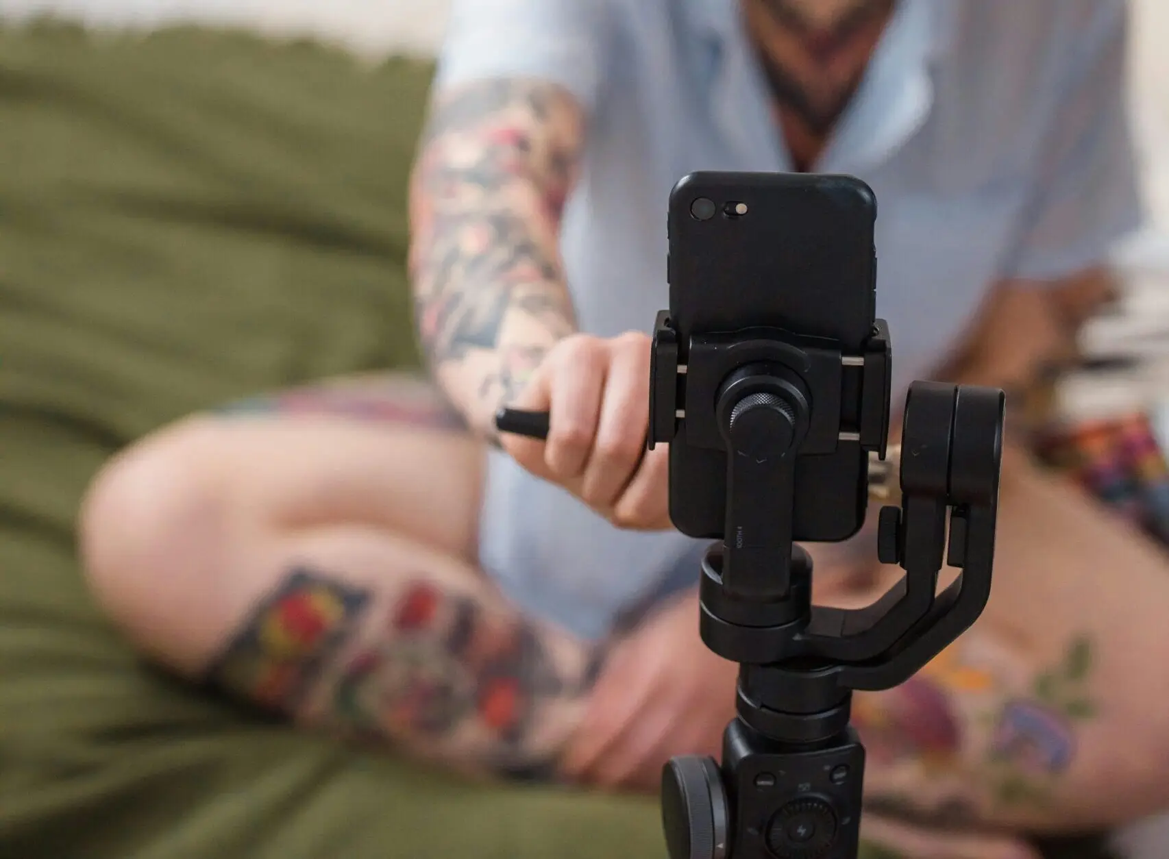 woman on bed recording on tripod