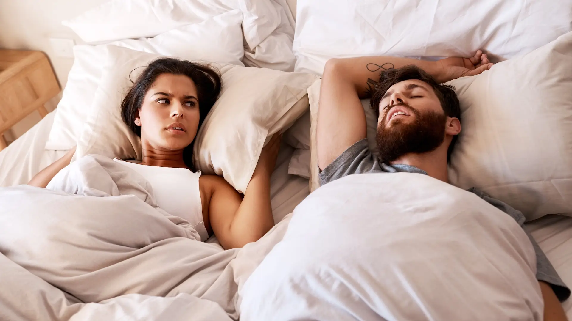 Bedroom, snore and couple sleep, frustrated and woman angry over snoring, problem and morning noise. Sleeping, home insomnia and relax girl with fatigue, tired and sleepless in apartment bed