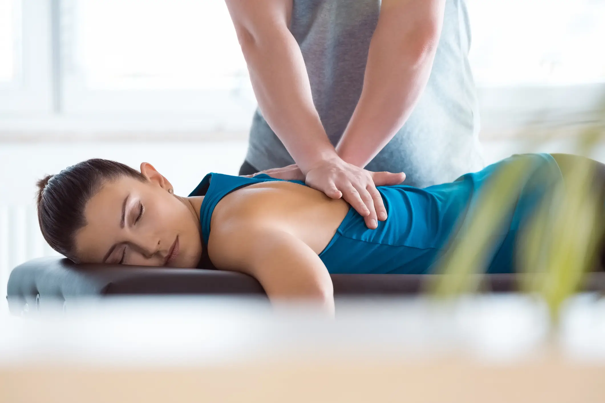Massage therapist giving back massage