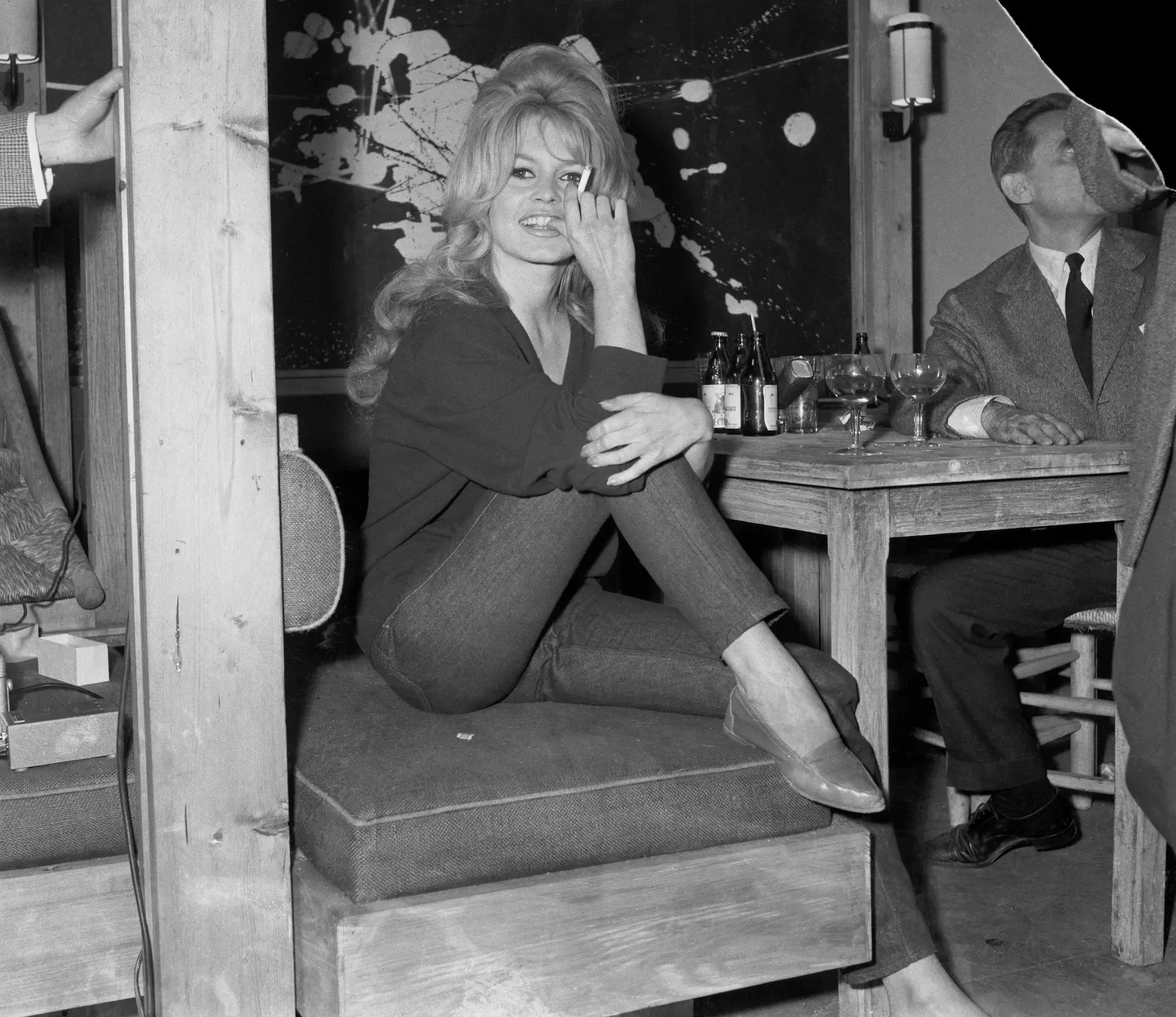 Clad in jeans and sweater, Brigitte Bardot receives newsmen on amovie set in Paris late May 31. She was working in the last scenes of her latest film La Verite. asked if she minded playing in nude films, Miss Bardot replied, "There are no nude films, there are only good or bad movies".