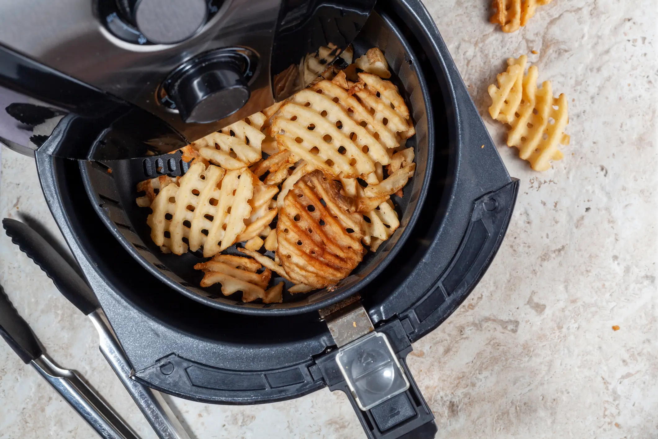 Crumbs and grease can build up in an air fryer quicker than you think (Getty Images/Grandbrothers)