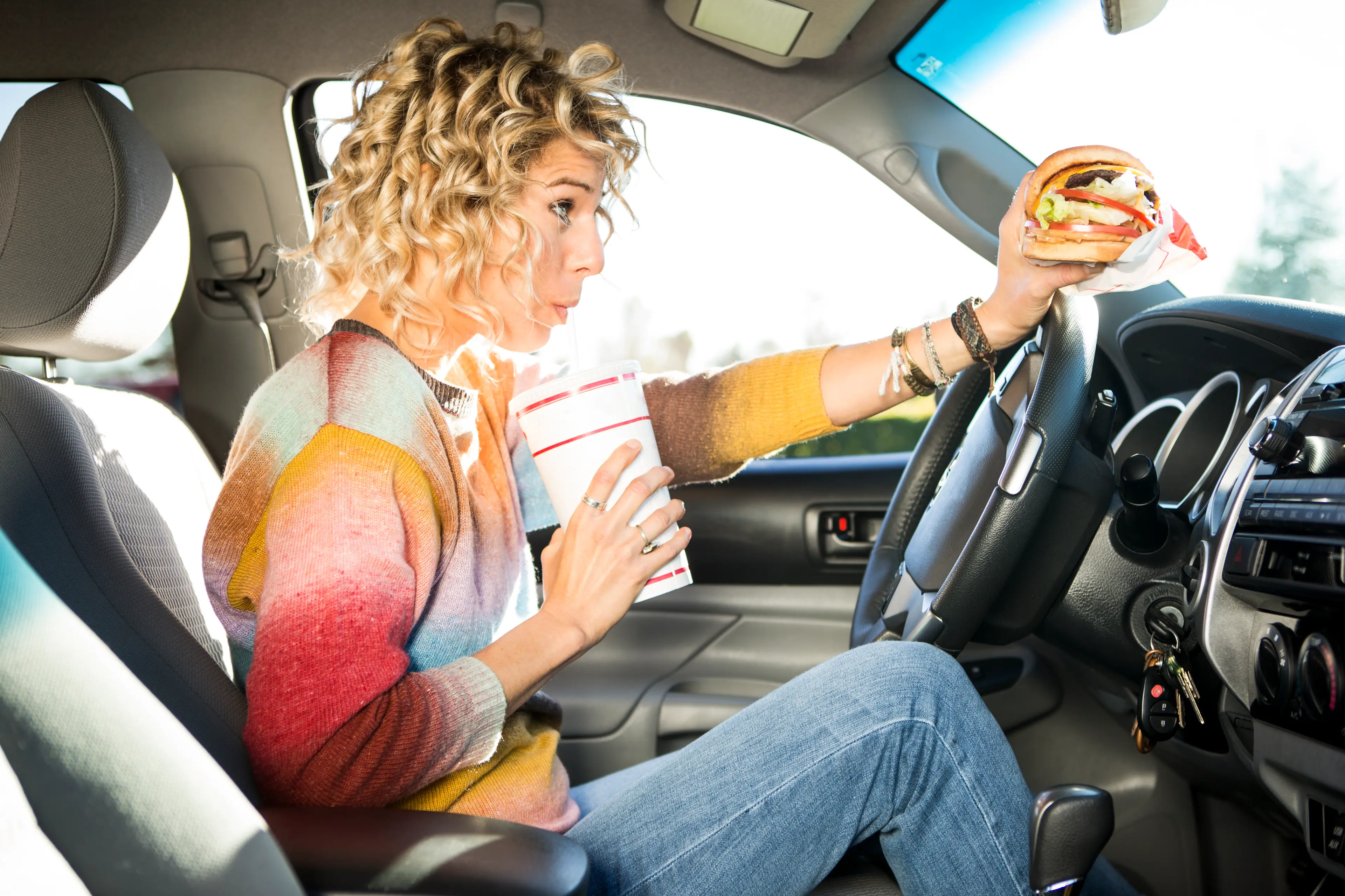 Eating and drinking in your car could land you a serious fine (Getty Stock Image)