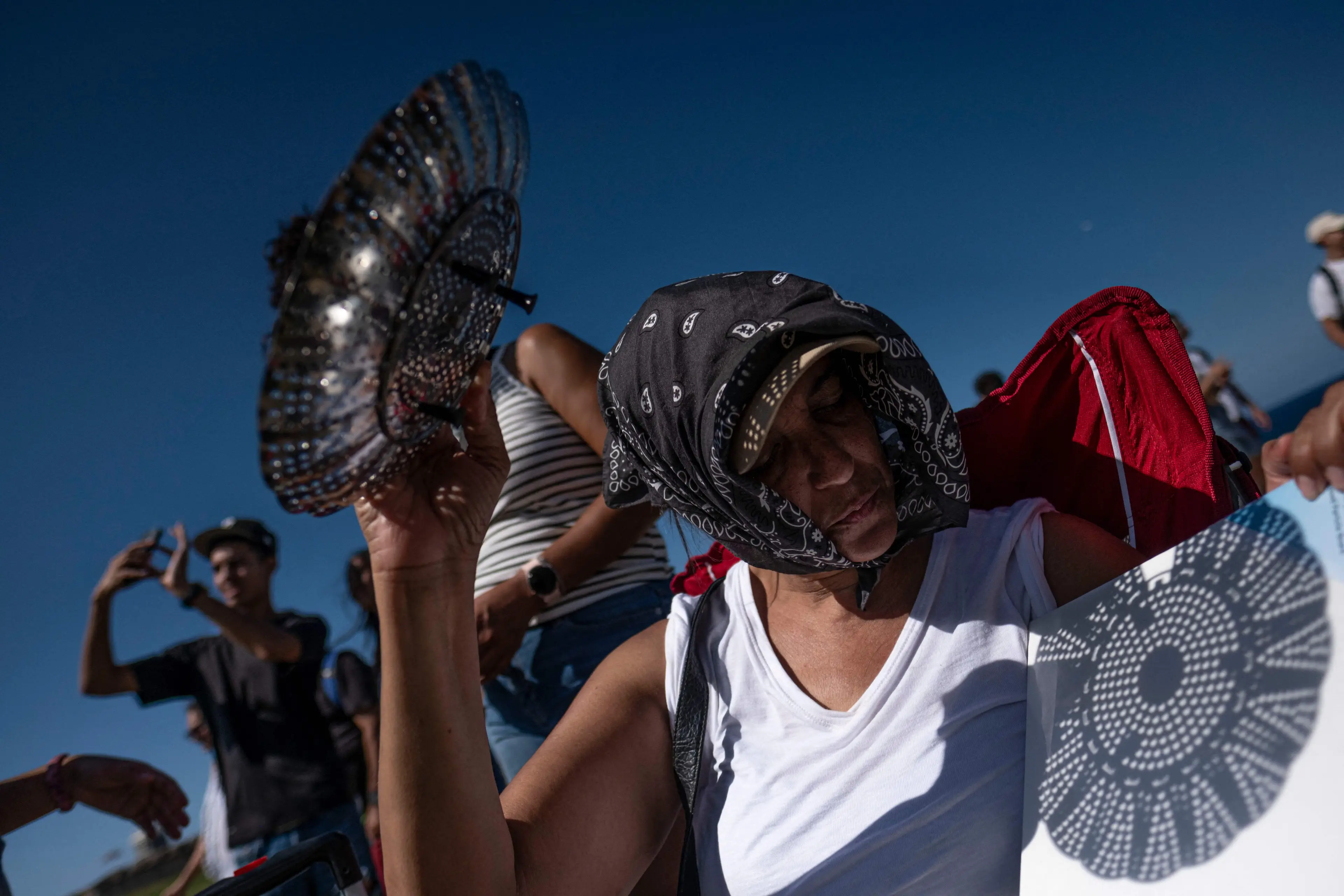 It's advised you use a blank piece of card or paper with the colander (RICARDO ARDUENGO/AFP via Getty Images)