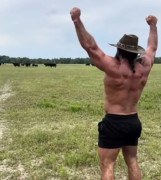 Liver King working out in front of a herd of bulls (Liver King/YouTube)