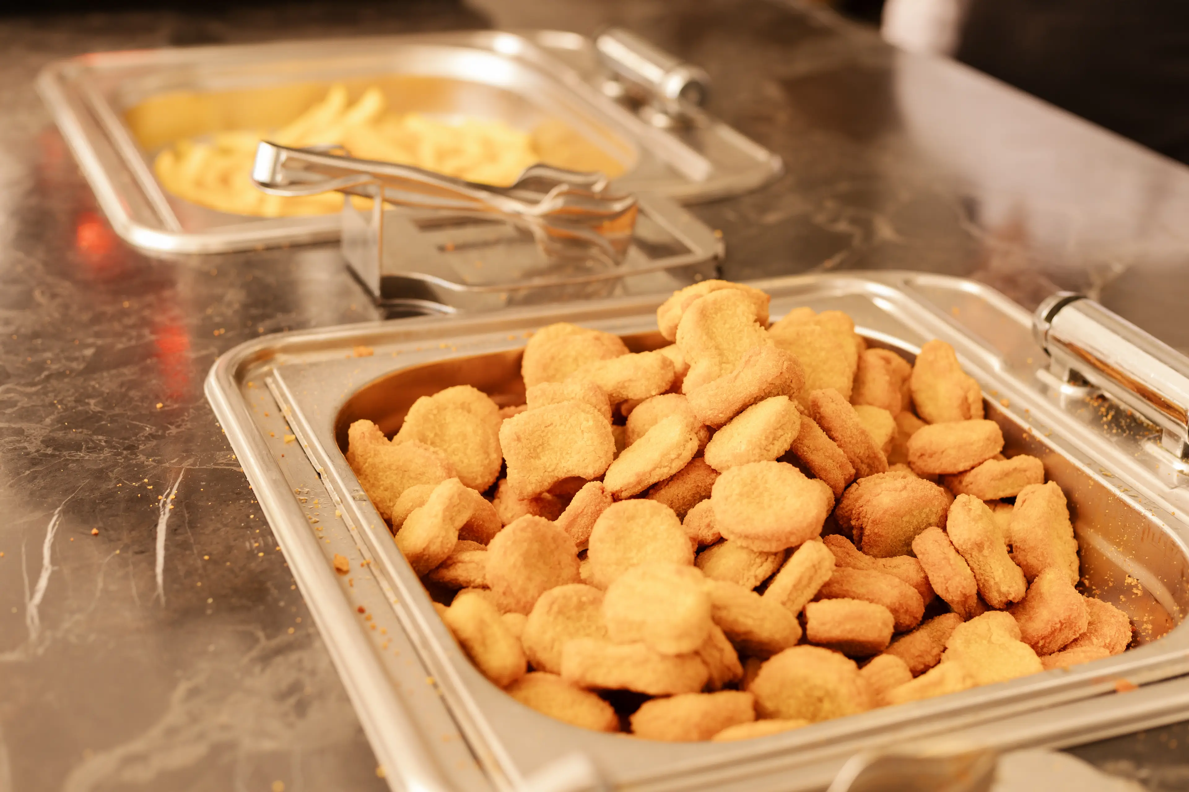 HFSS foods like chicken nuggets and chips are being served too often to school kids, a new study suggests (Getty Stock Image)