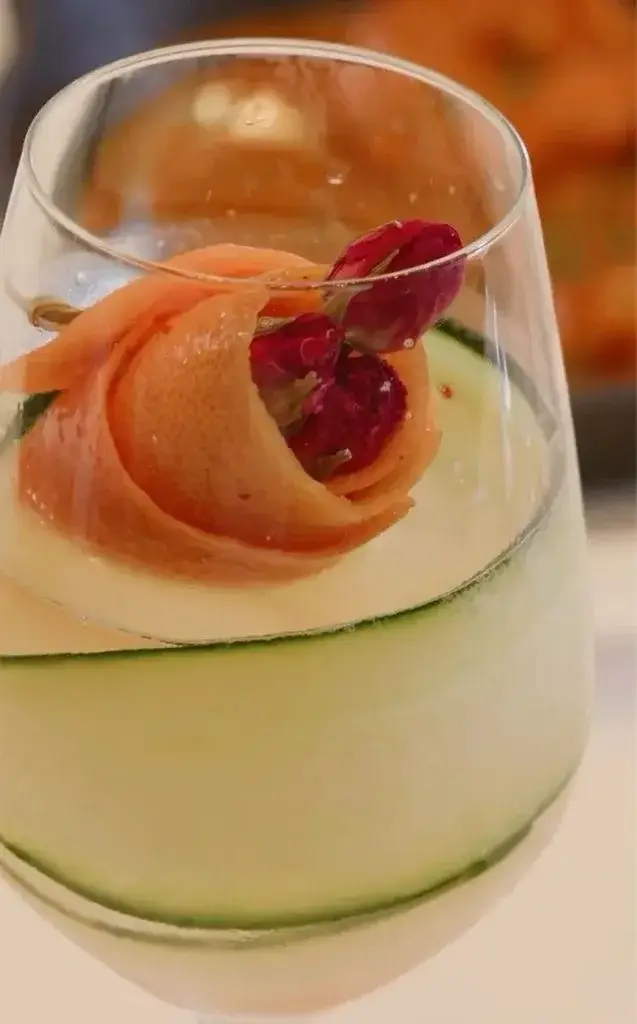 The cocktail features a bright floral garnish (1587 Prime/Instagram)
