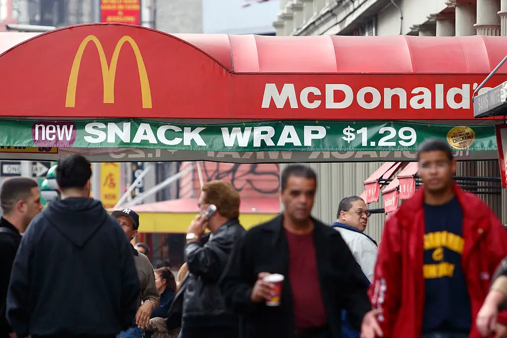 Pedestrians walk past a McDonald's restaurant promoting the then-new Snack Wrap in New York in 2006. (Adam Rountree/Bloomberg via Getty Images)