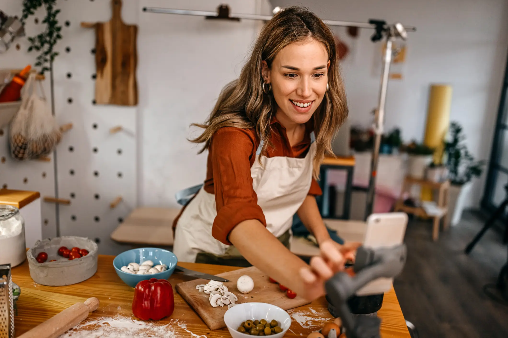 Touching your phone whilst cooking could make you ill (Getty/mixetto)