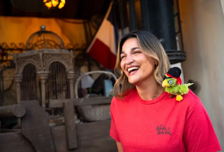Merch including themed t-shirts and a shoulder plushie parrot will be available (Disney)
