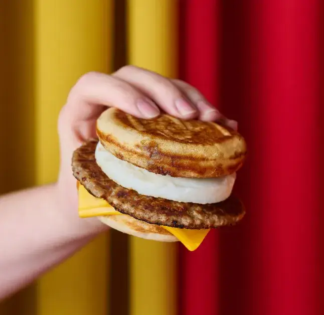 The breakfast sandwich will consist of two griddles, a fried egg, sausage patty, and cheese (McDonald's)