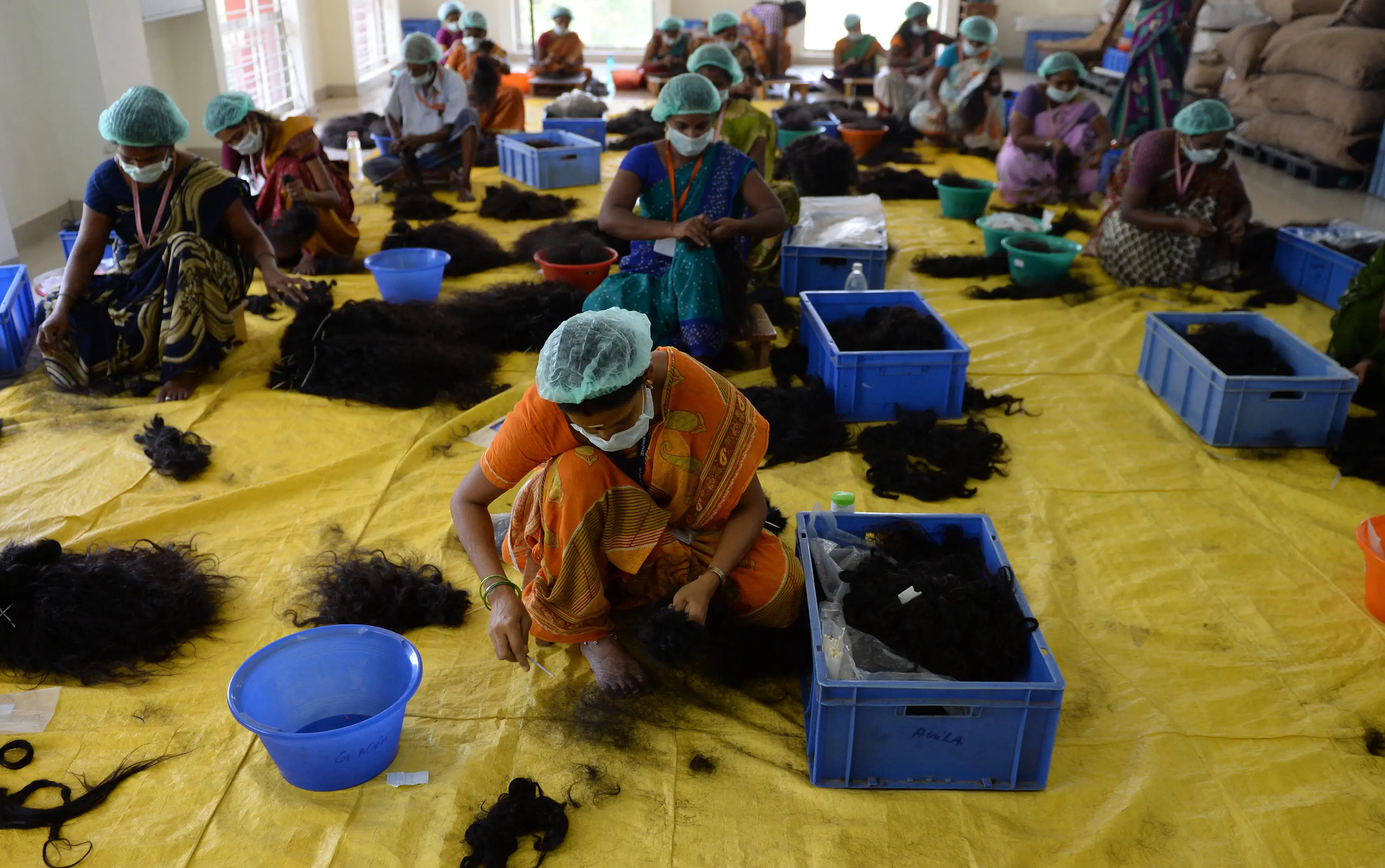 Tangled hair from combs and drains is treated before being sent to be made into extensions and wigs (ARUN SANKAR/AFP via Getty Images)