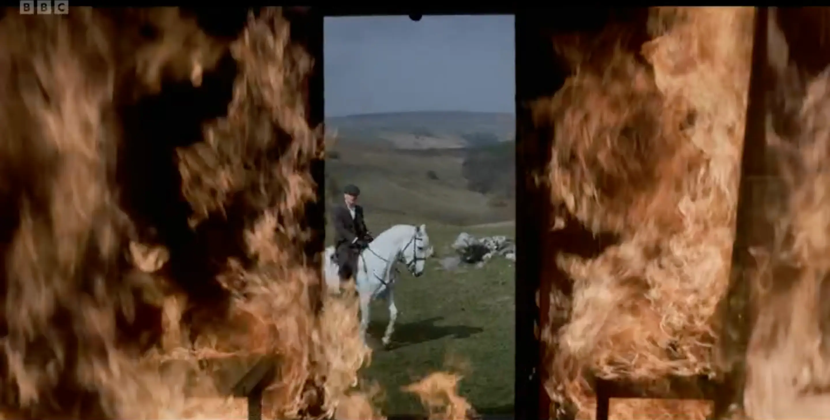 Tommy is seen riding a white horse. (