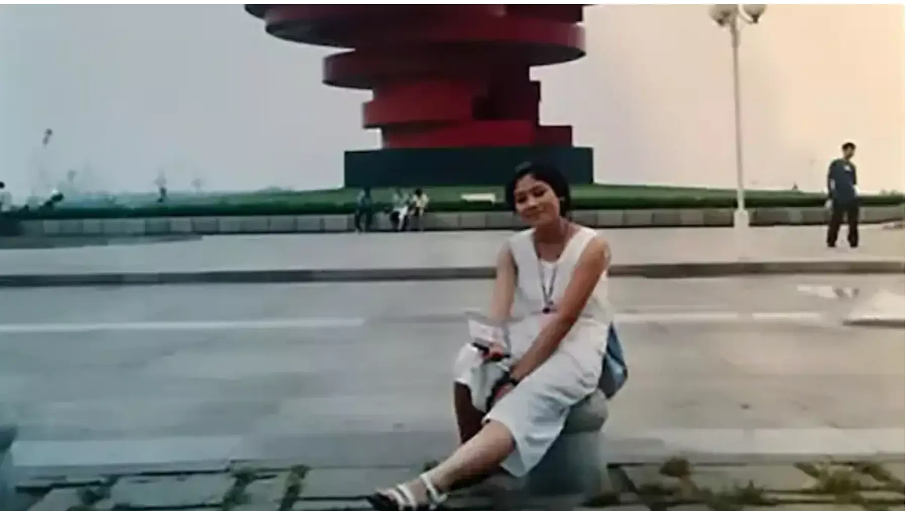 That's right! The man in the background of this photo went on to become the woman's husband (ChannelNewsAsia)