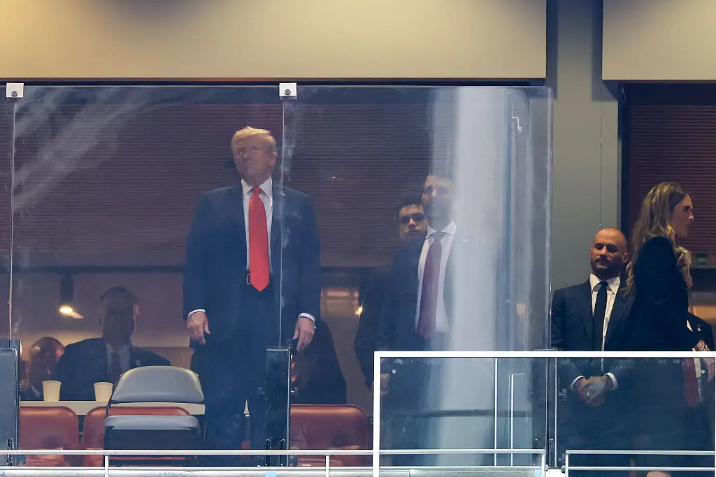 The US president also appears to be viewing the ceremony from behind another pane of bulletproof glass (Joe Raedle/Getty Images) 